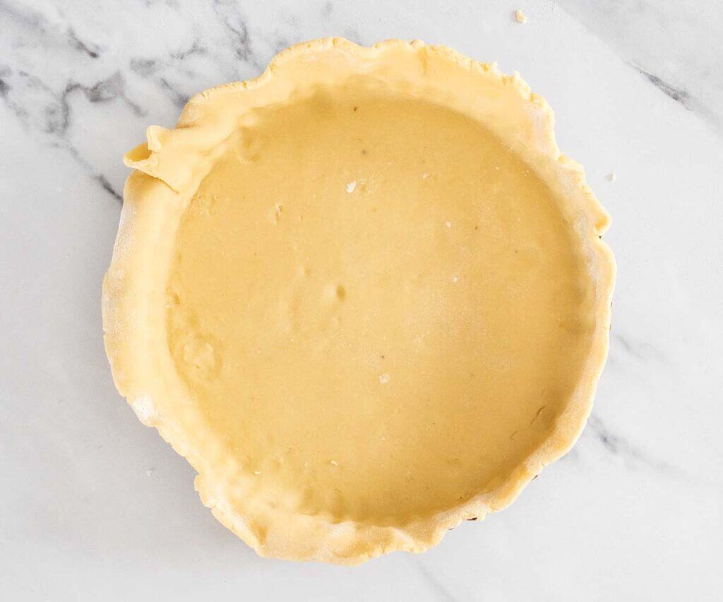 Top down view of the pastry in the tart pan, ready to chill.
