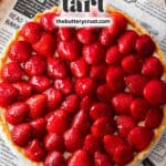 Top down view of a whole tart topped with glossy strawberries with a banner across the top saying "french strawberry tart".