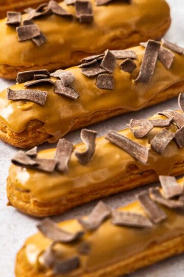 Closeup of 4 coffee eclairs.