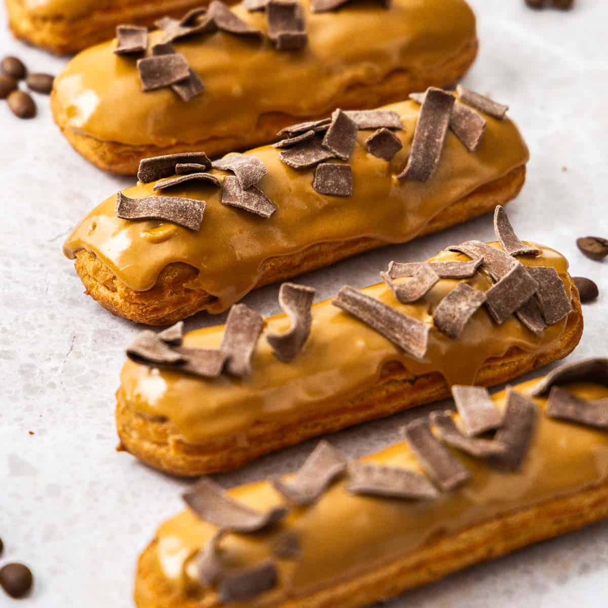 Closeup of 4 coffee eclairs.
