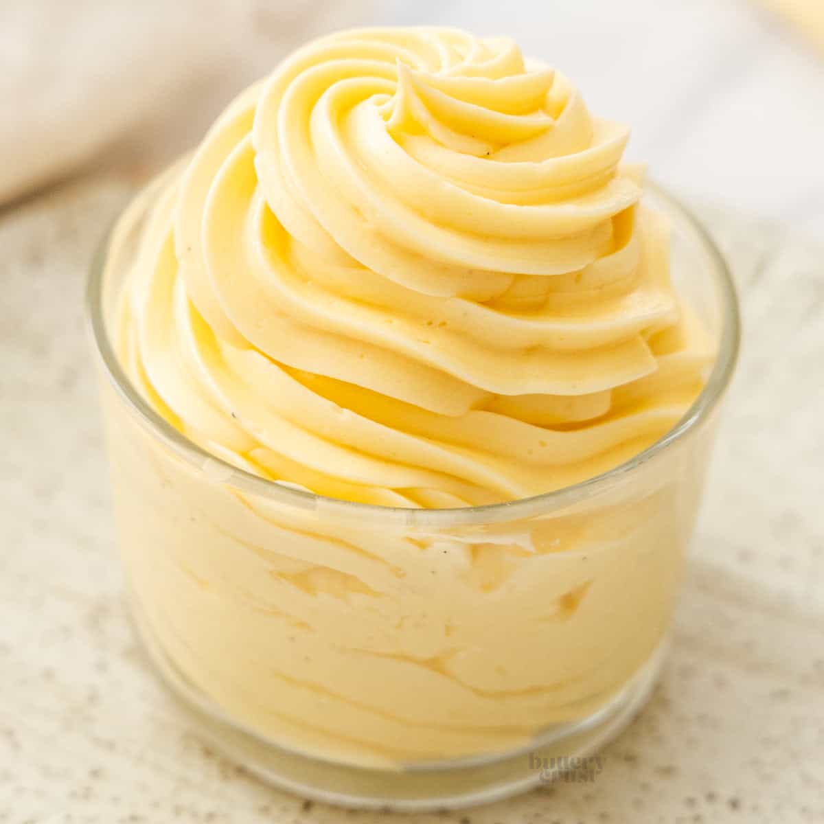 Mousseline cream piped in a swirl into a glass.