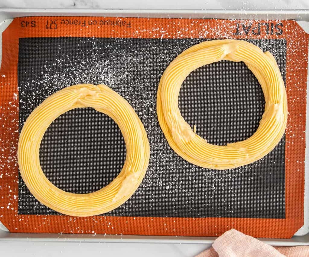 Each ring of dough topped with a larger single ring of dough.