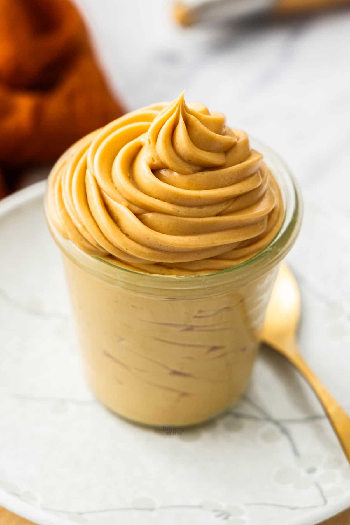 Praline cream piped into a jar in a big swirl.