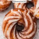Extreme closeup of an iced French cruller.