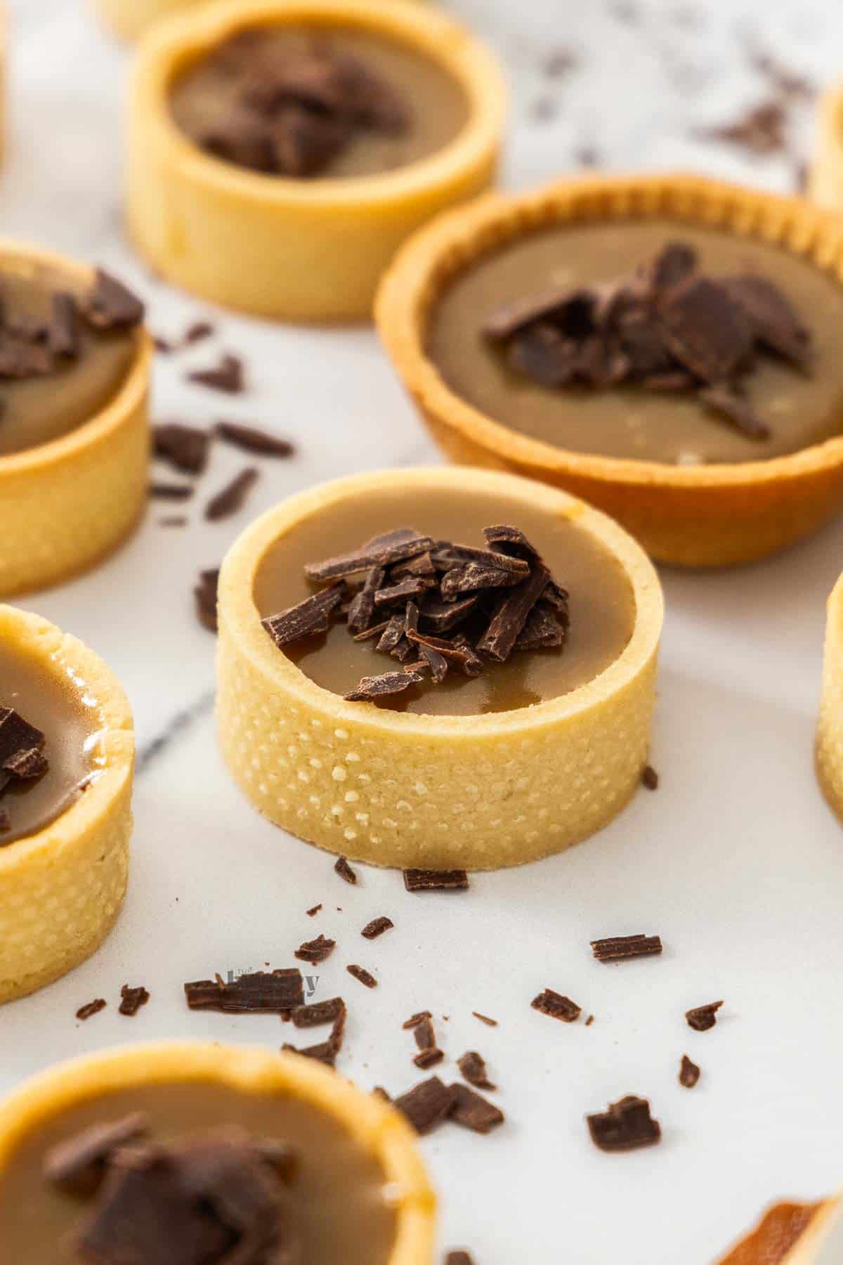Closeup of a butterscotch tartlet topped with chocolate.