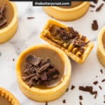 Top down view of a butterscotch tartlet with one broken open to show the butterscotch texture.