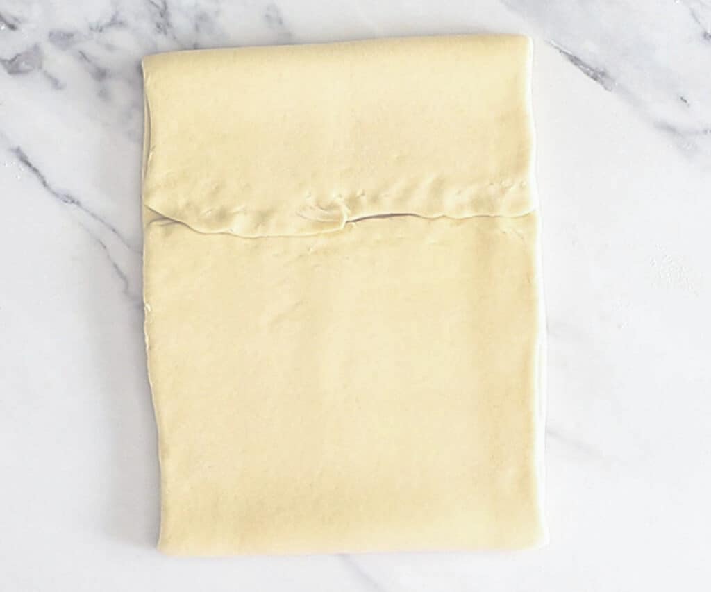 Teh dough rolled and folded.