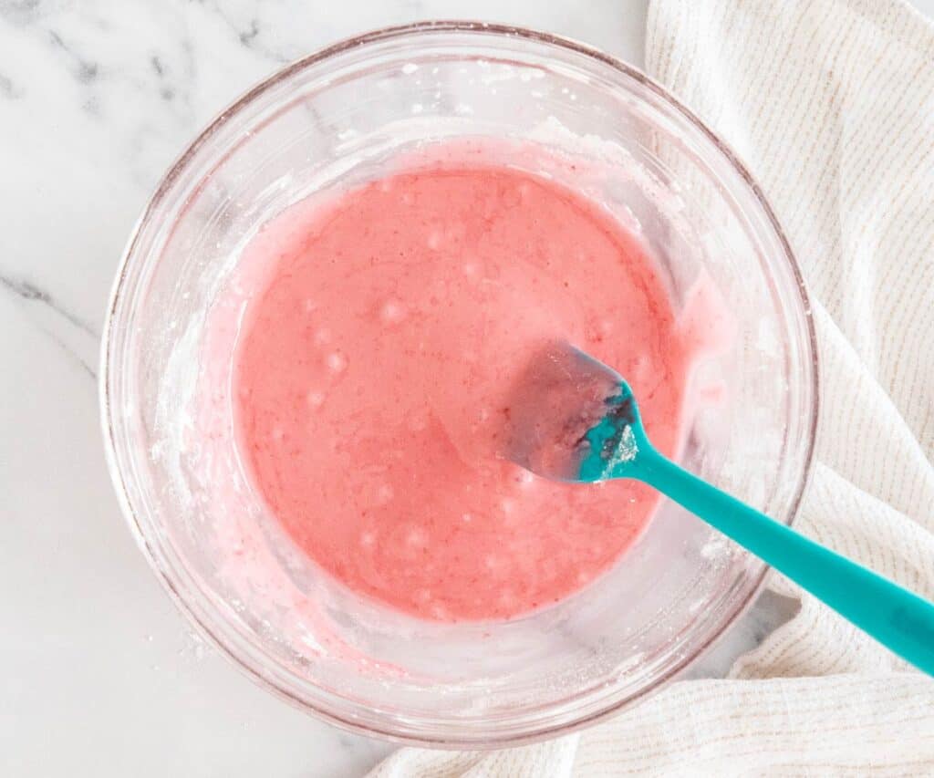 Raspberry glaze in a glass bowl.