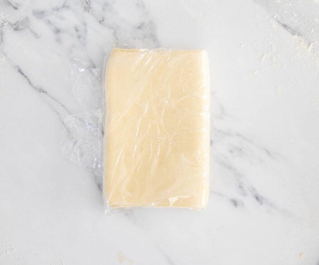 The dough covered in plastic wrap.