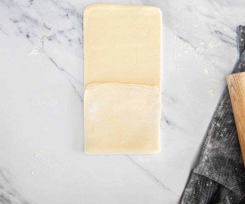 The rolled out dough with one third folded up.