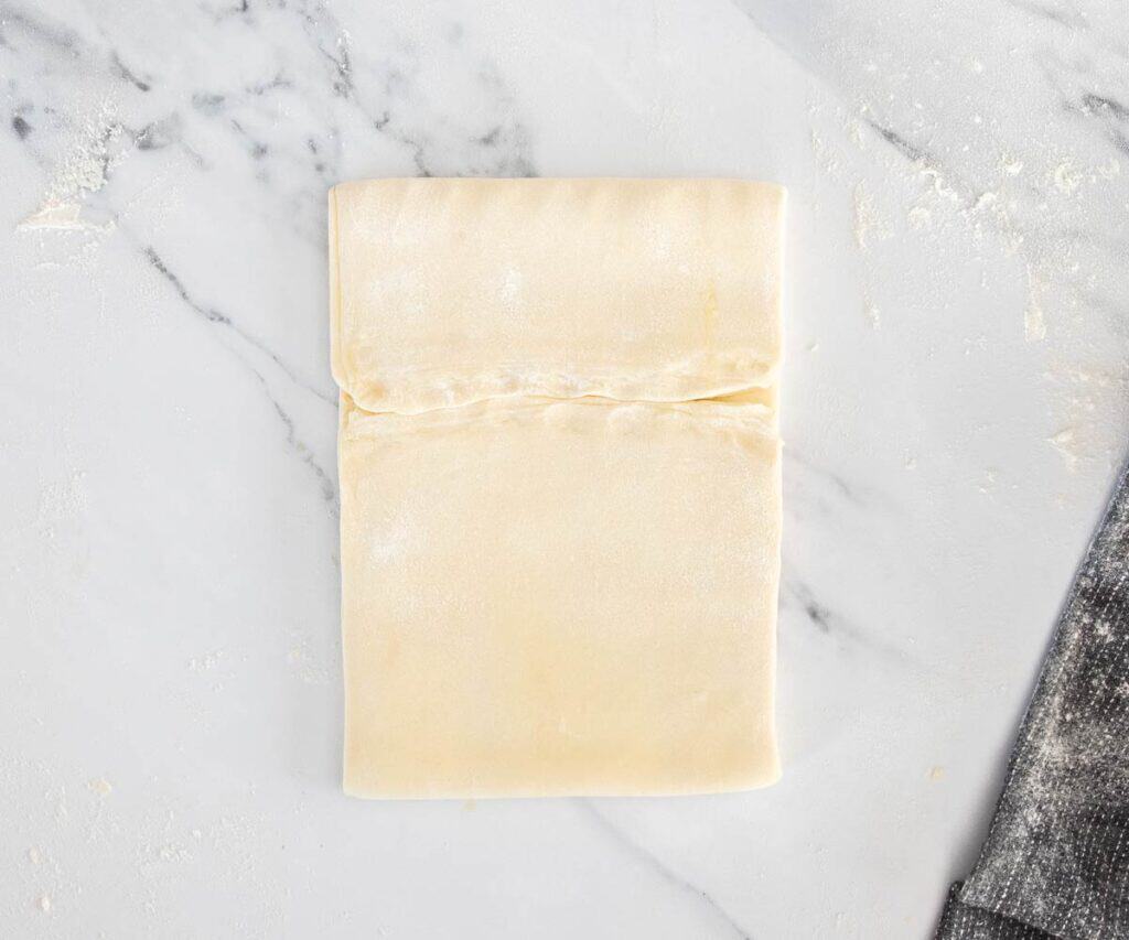 The top of the dough folded down to meet the seam of the other third.