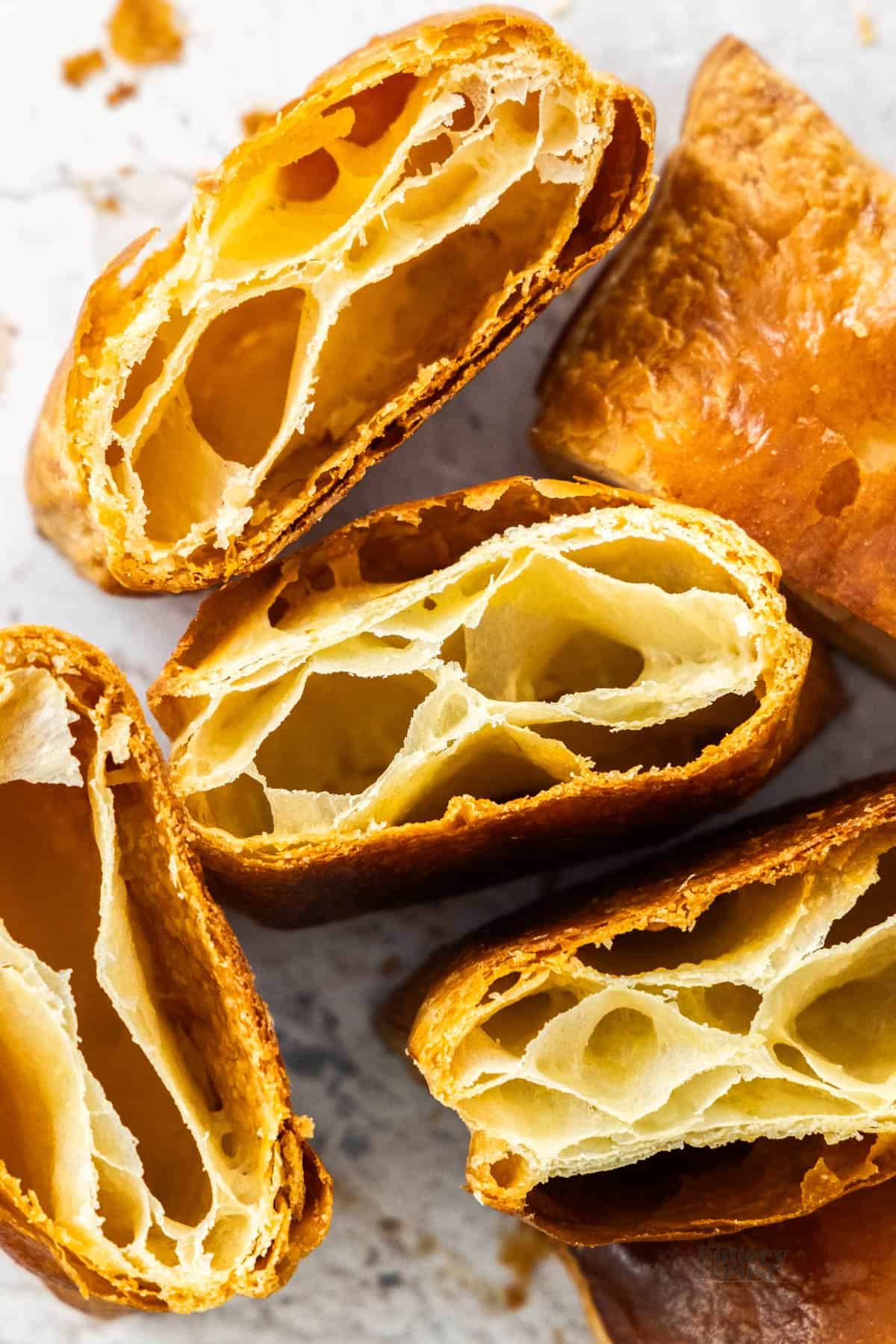 Top down view of pieces of baked rough puff pastry.