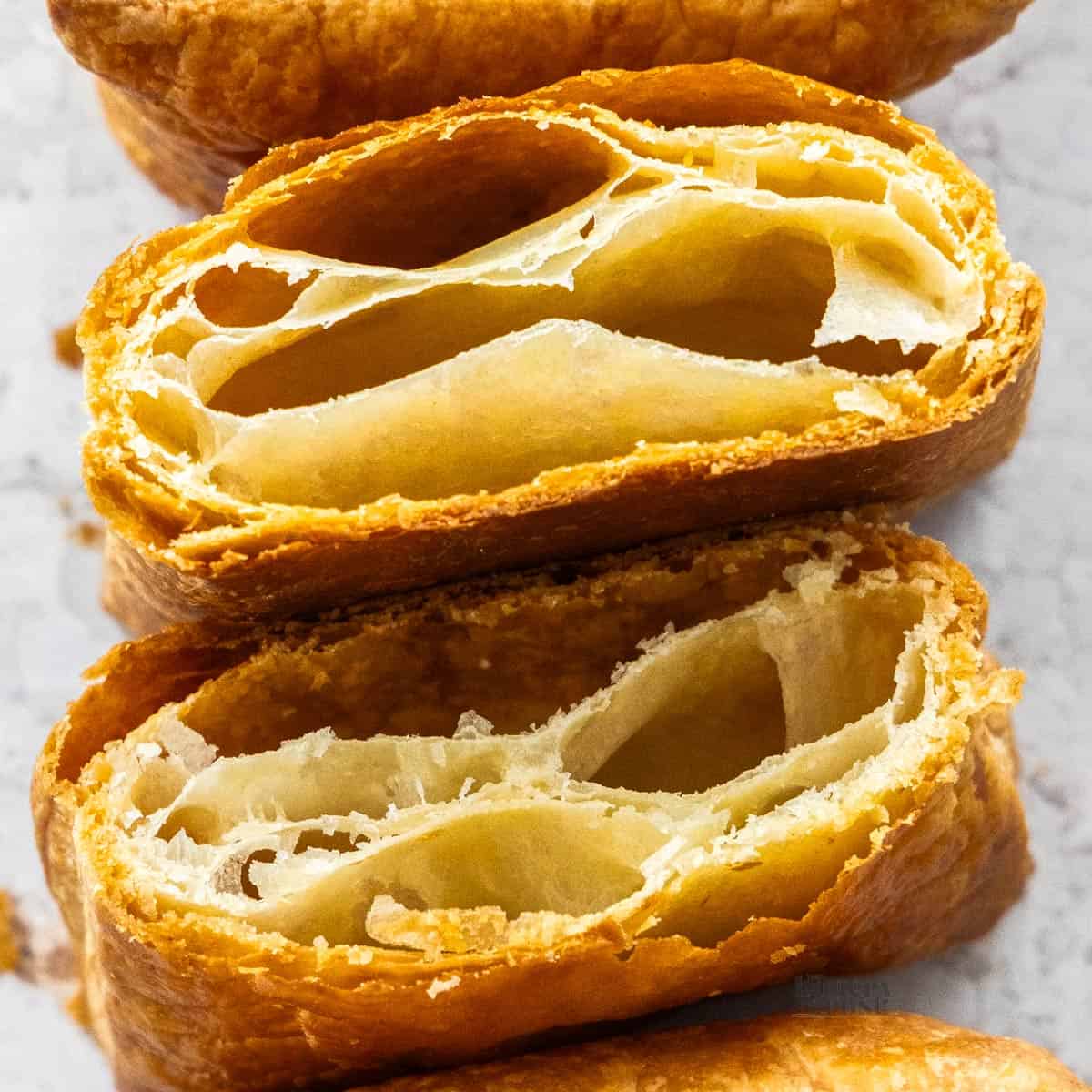 Two super-close up pieces of rough puff pastry.