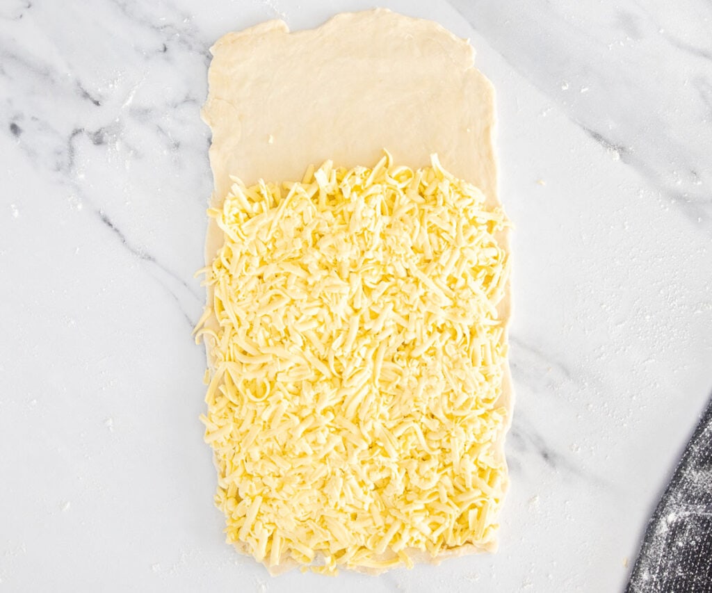 Grated butter pressed over two thirds of the dough.