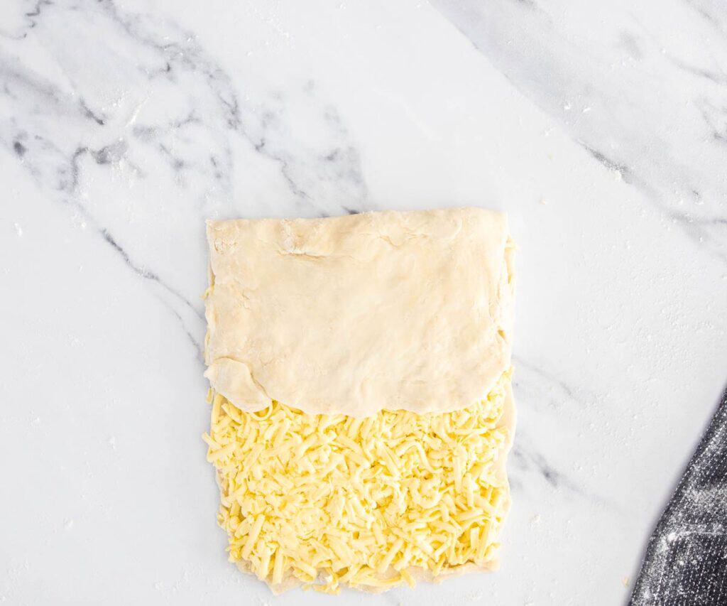 Bare dough folded down over the buttered dough.