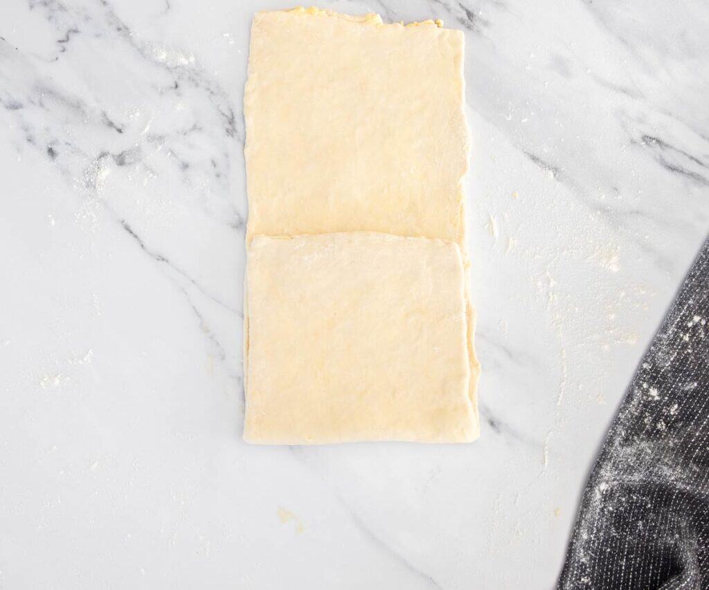 The dough rolled out with the bottom third folded up over the middle.